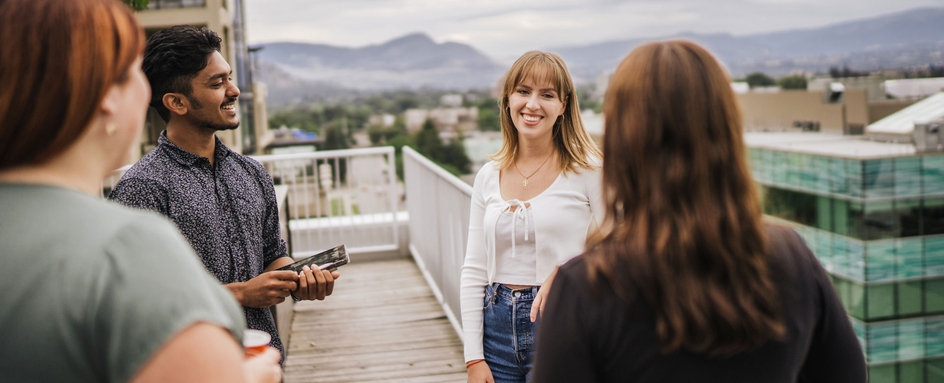 Entrepreneurship@UBCO students talking on the roof of the Innovation Centre in Kelowna.