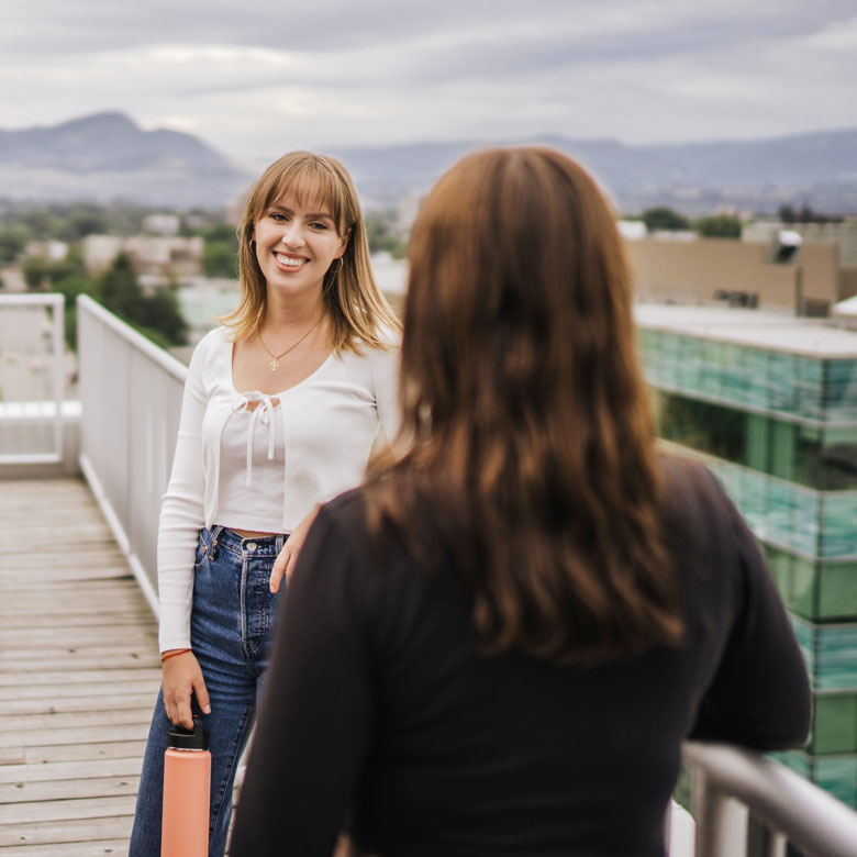 Entrepreneurship@UBCO students talking on the roof of the Innovation Centre in Kelowna.